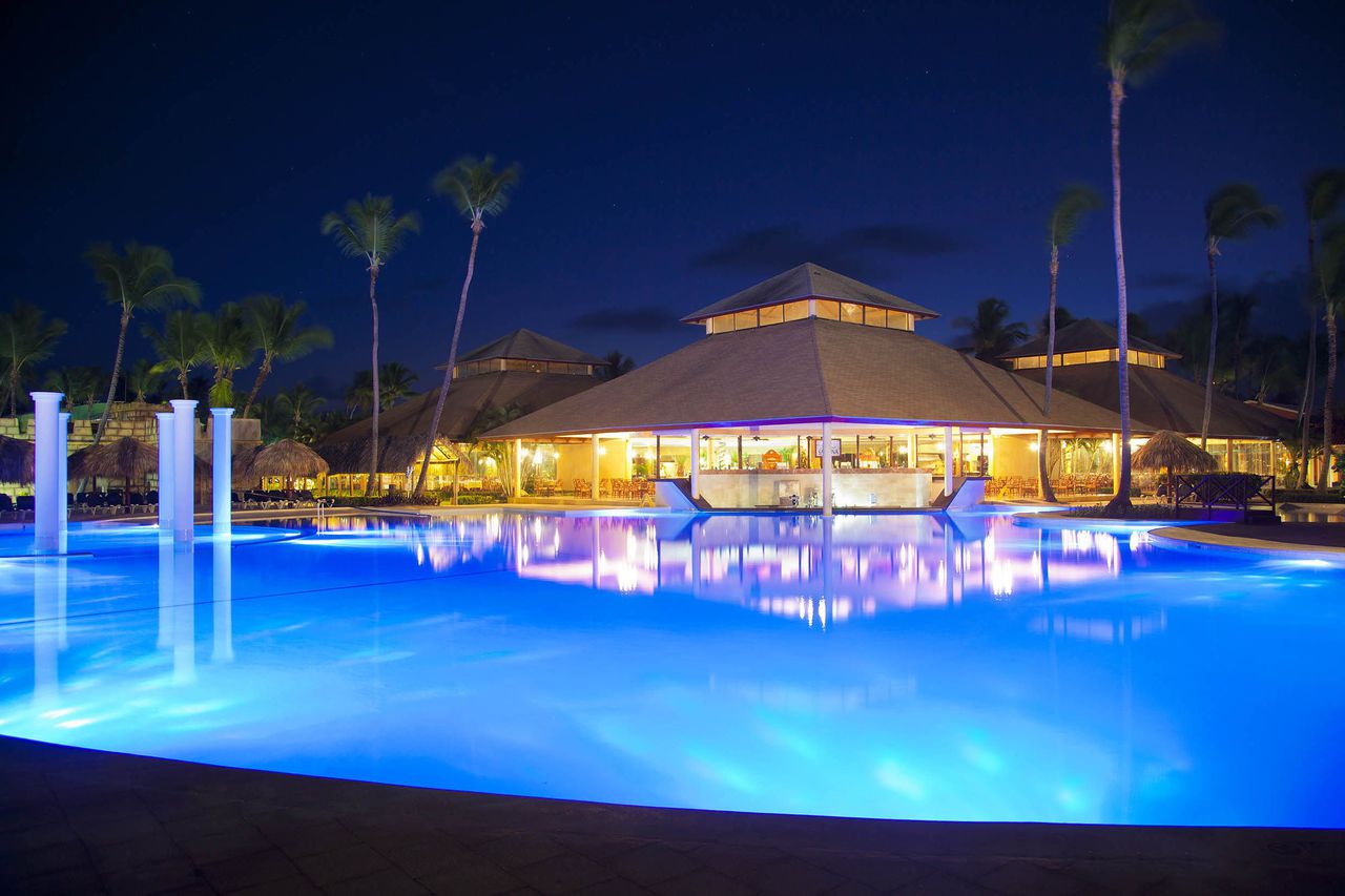 Bavaro Beach at Grand Palladium Palace with fine white sand, turquoise Caribbean waters, and complimentary loungers and umbrellas