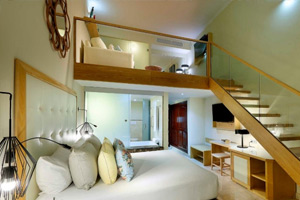 Loft Suite Garden View featuring distinctive two-story duplex layout with bedroom on lower level and living area with sofa bed upstairs