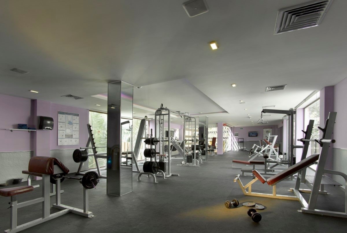 Fitness center with modern cardio equipment, weights, and resort views