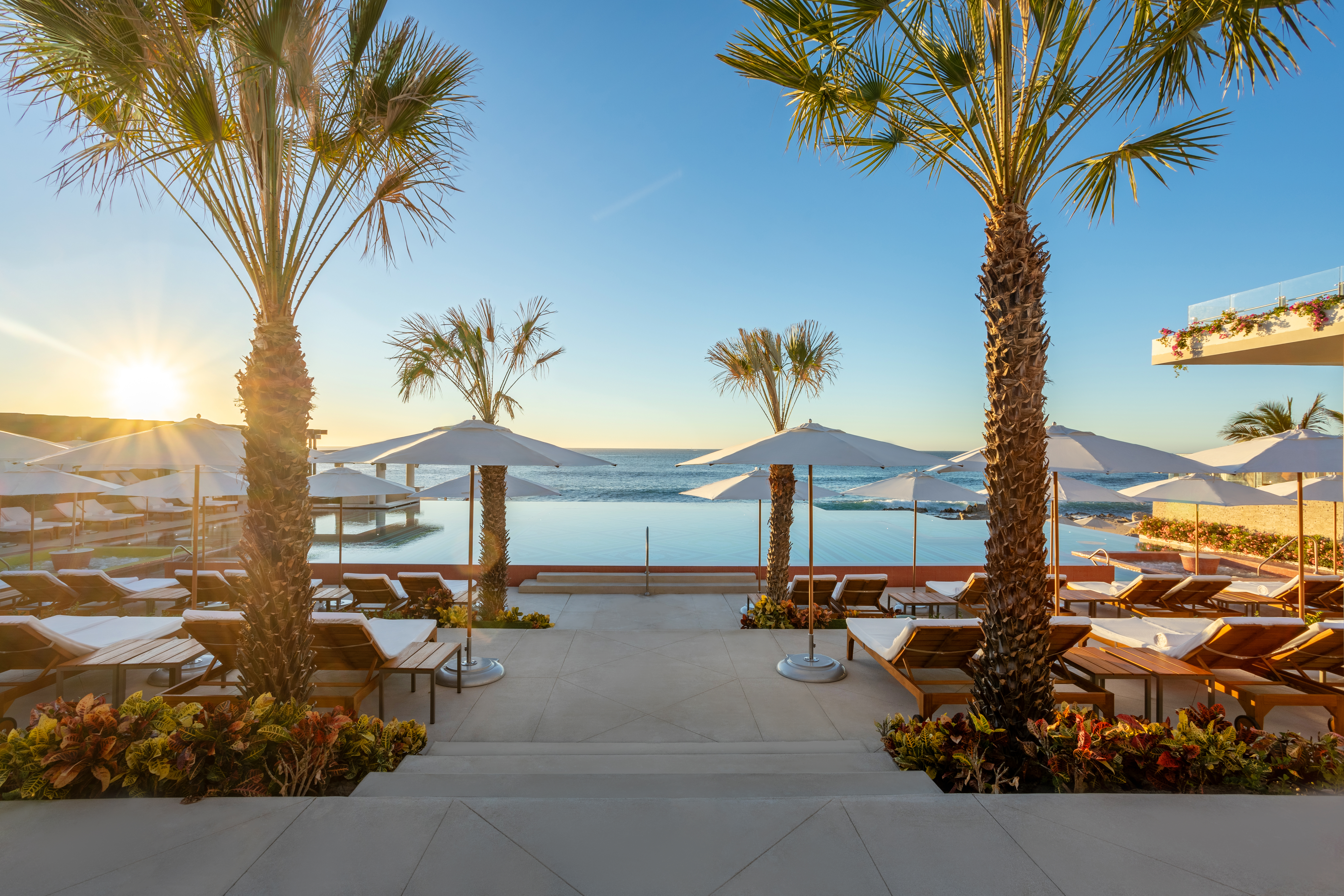 Heated infinity pool cascading toward the Sea of Cortez