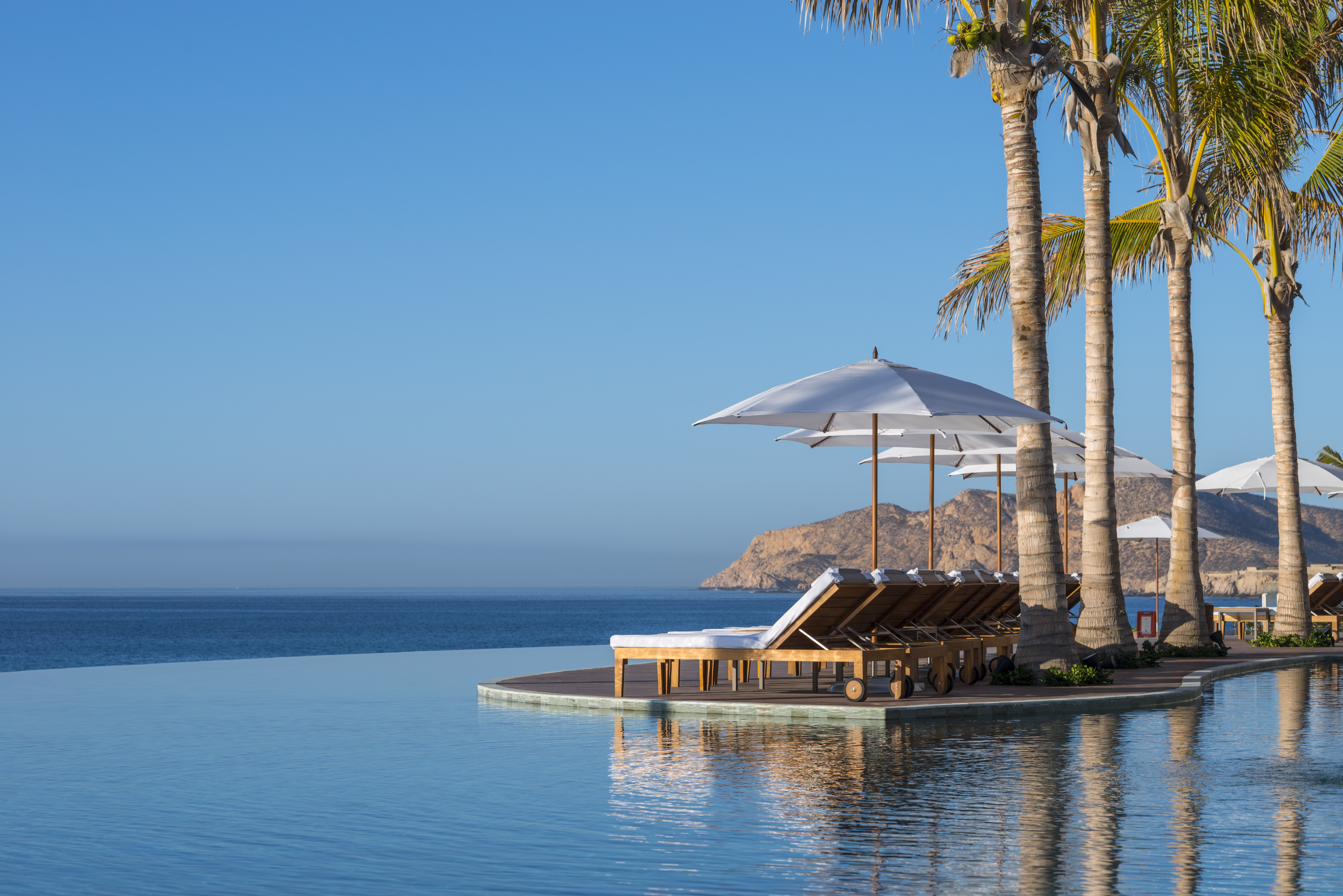 Three-tiered infinity pools cascading toward the Sea of Cortez