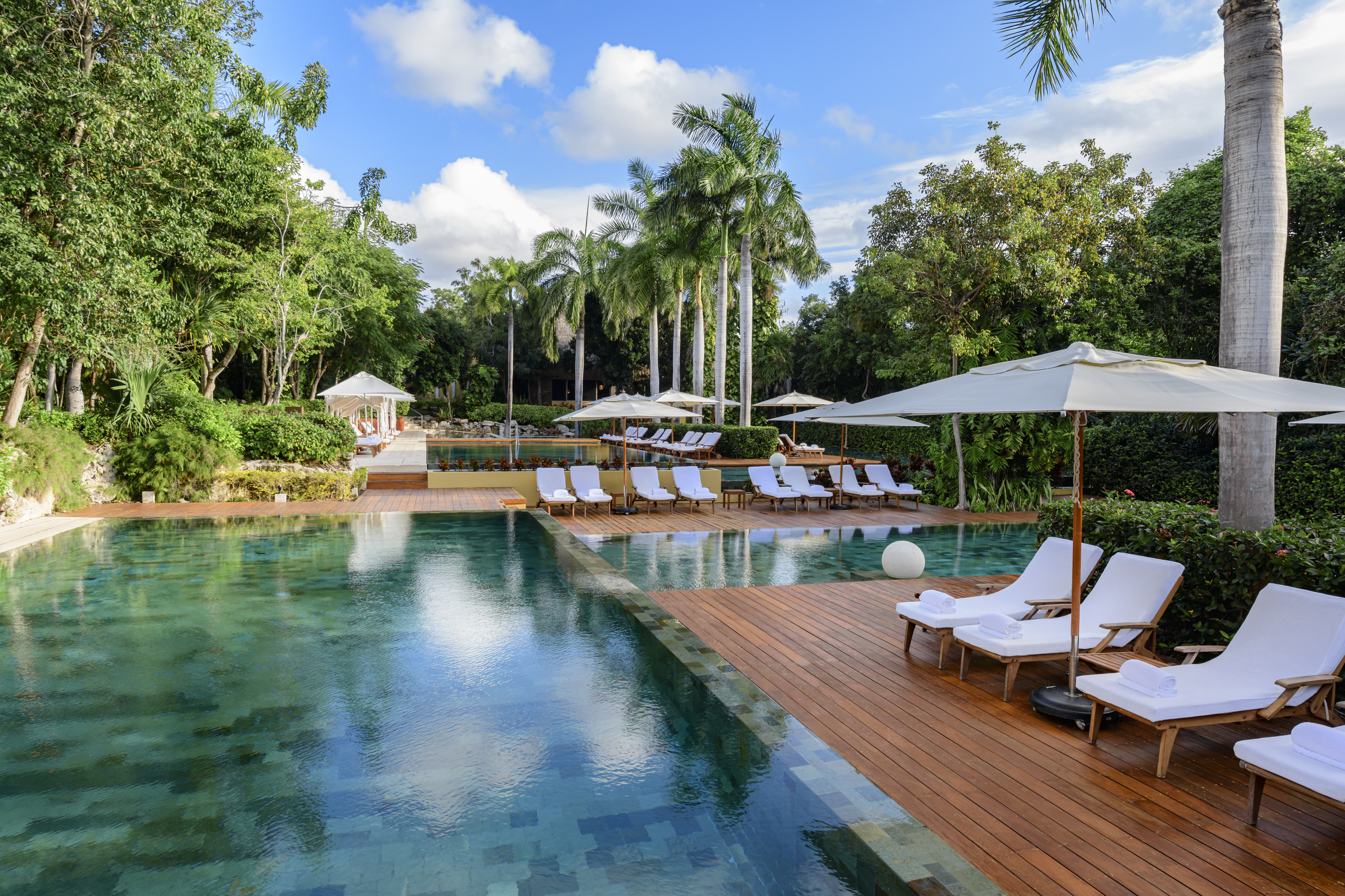 Zen Grand multi-tiered infinity pool surrounded by Mayan jungle