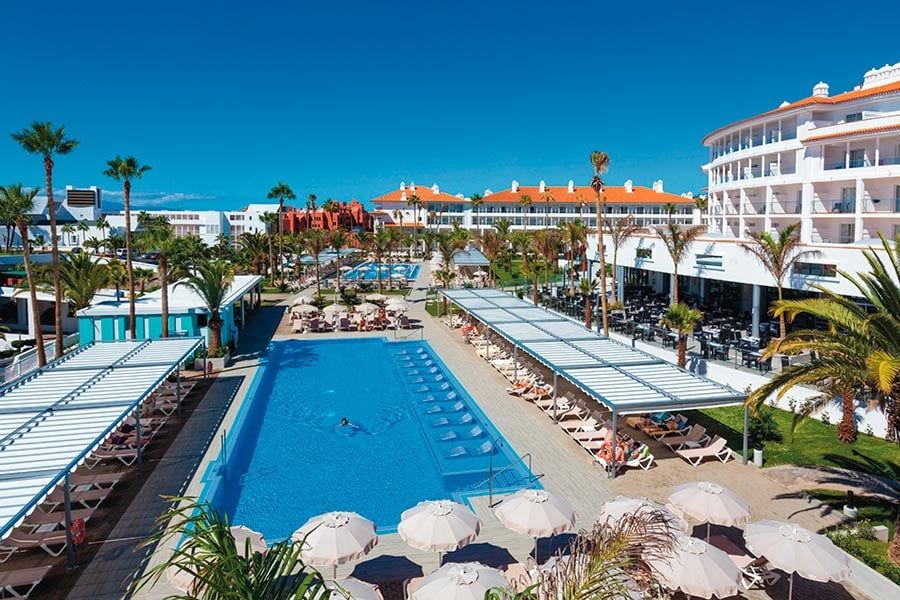 Swimming pool area at Hotel Riu Arecas