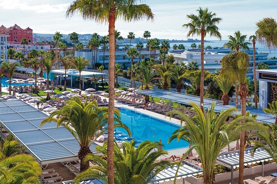 Swimming pool area at Hotel Riu Arecas