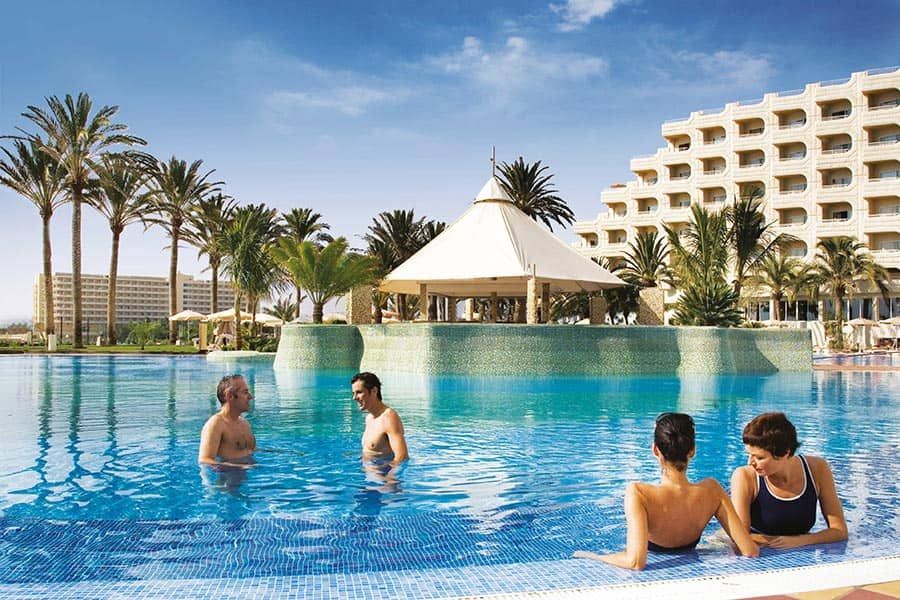 Swimming pool area at Hotel Riu Palace Tres Islas