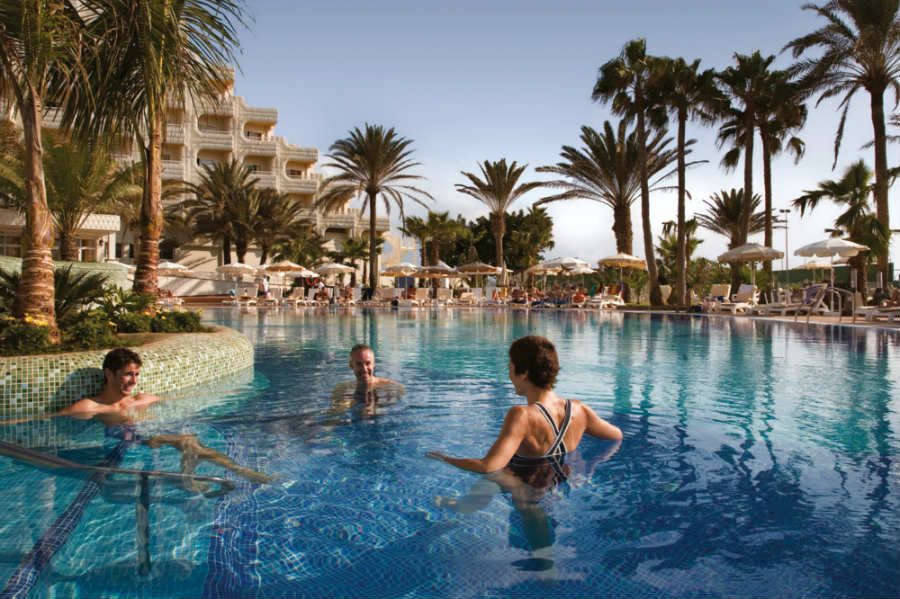 Swimming pool area at Hotel Riu Palace Tres Islas