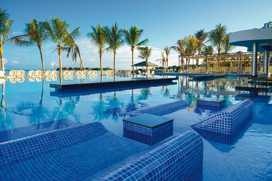 Swimming pool area at Hotel Riu Reggae