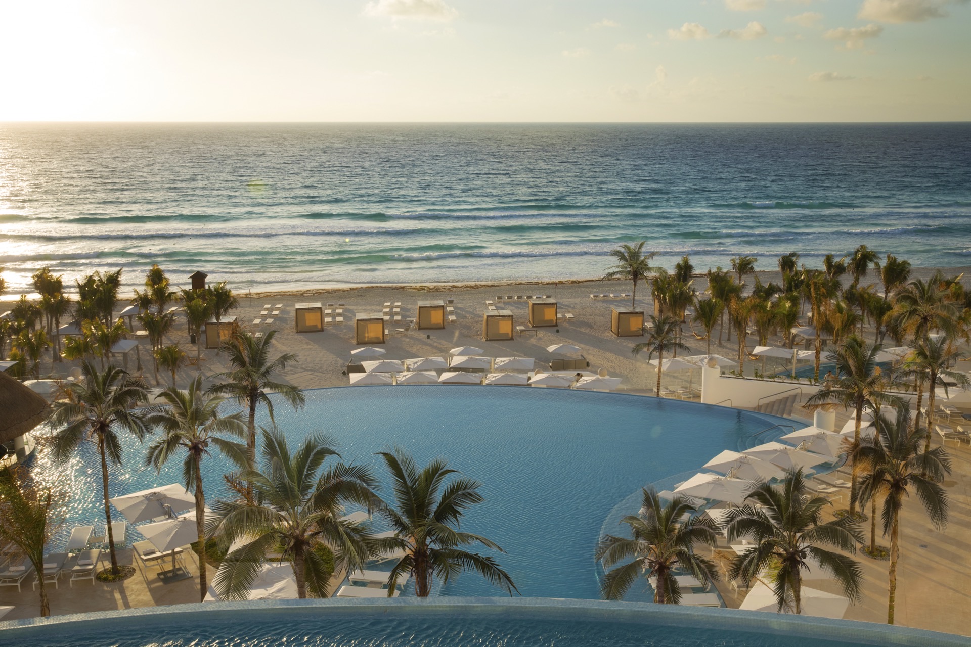 Beachfront pool and white-sand beach at Le Blanc Spa Resort Cancun from above