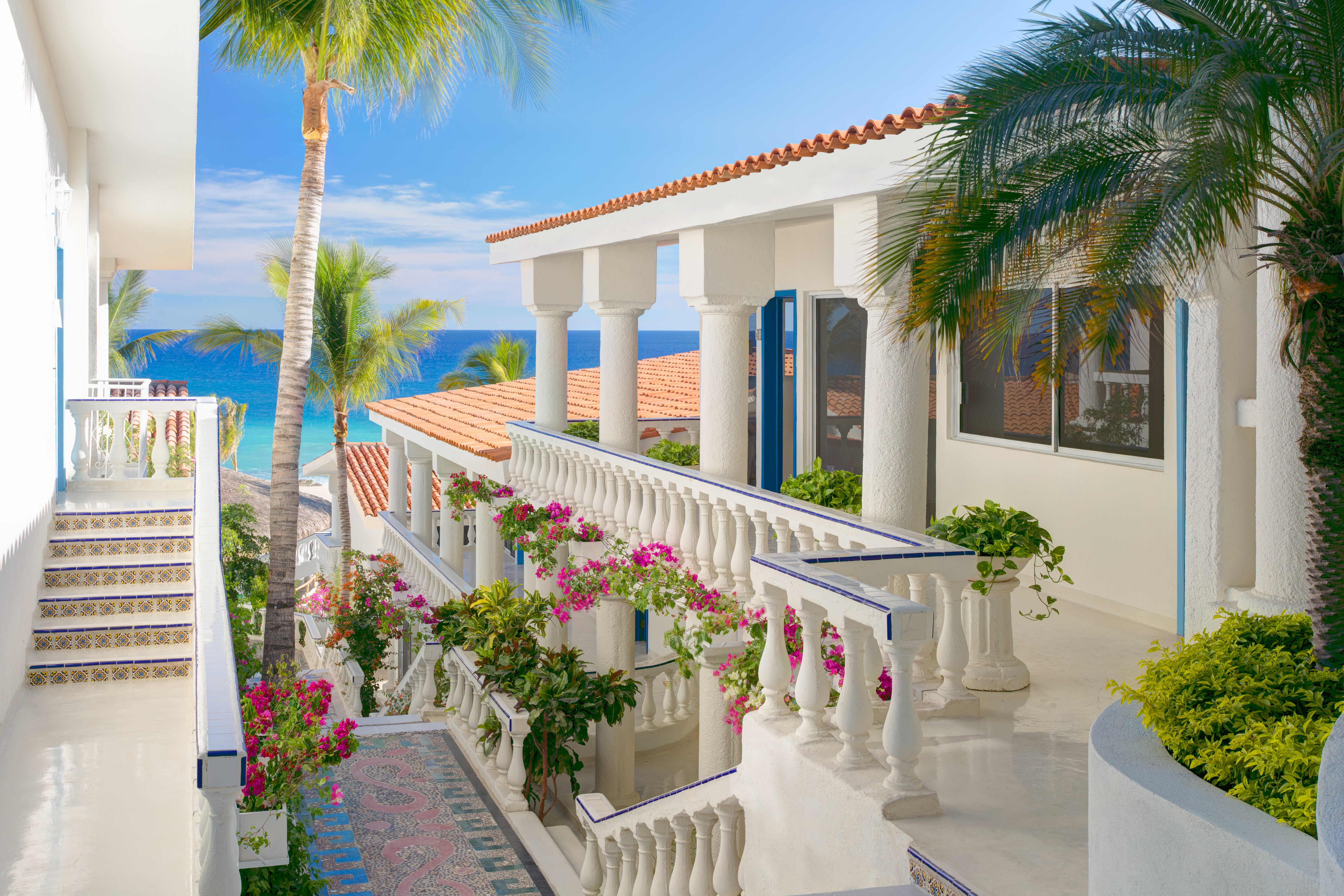 Whitewashed architecture and bougainvillea-draped pathways