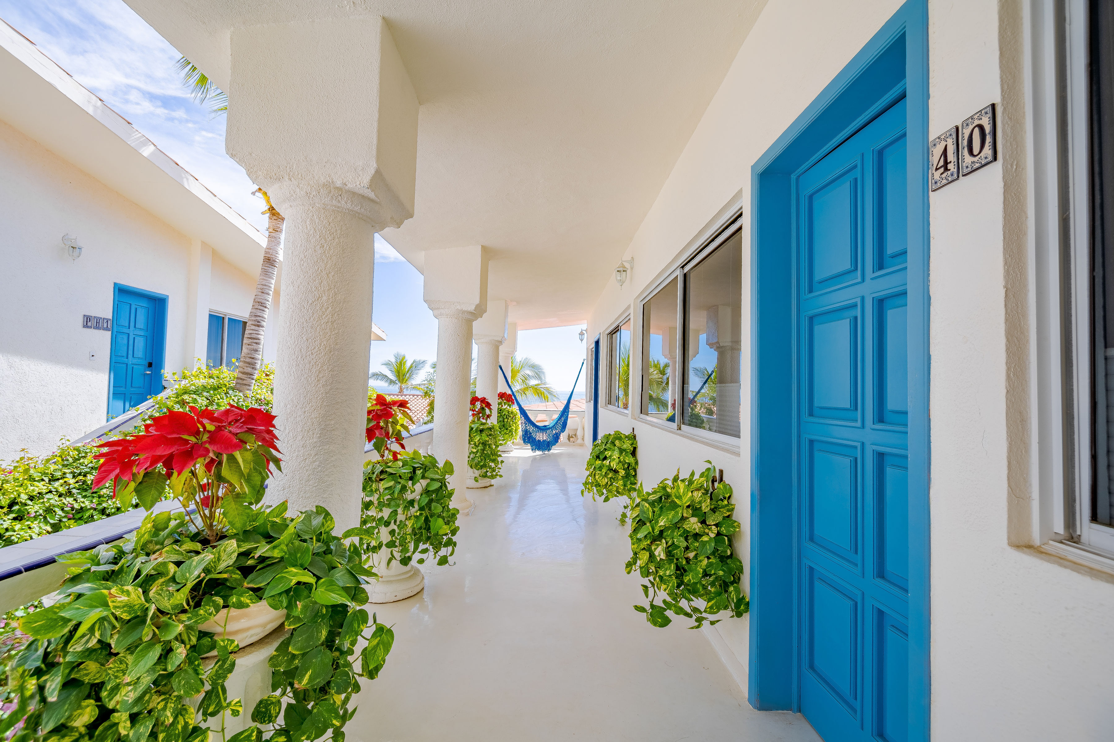 Santorini-inspired courtyard with ocean-blue doors