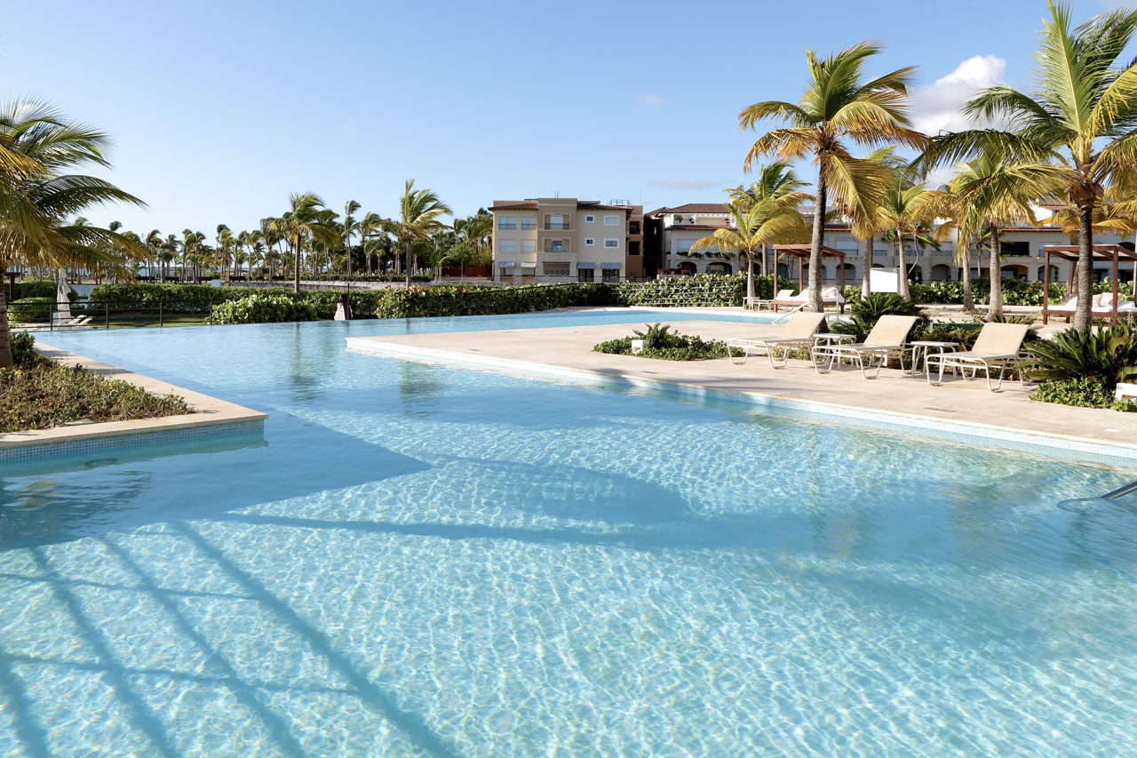 TRS Cap Cana resort exterior with tropical gardens and marina setting