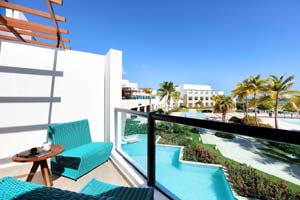 Junior Suite Poolside Ocean View — king bed with modern Mediterranean decor and marina views