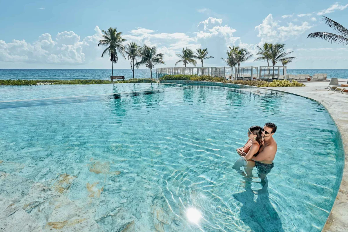 Helios pool area with loungers and Caribbean views