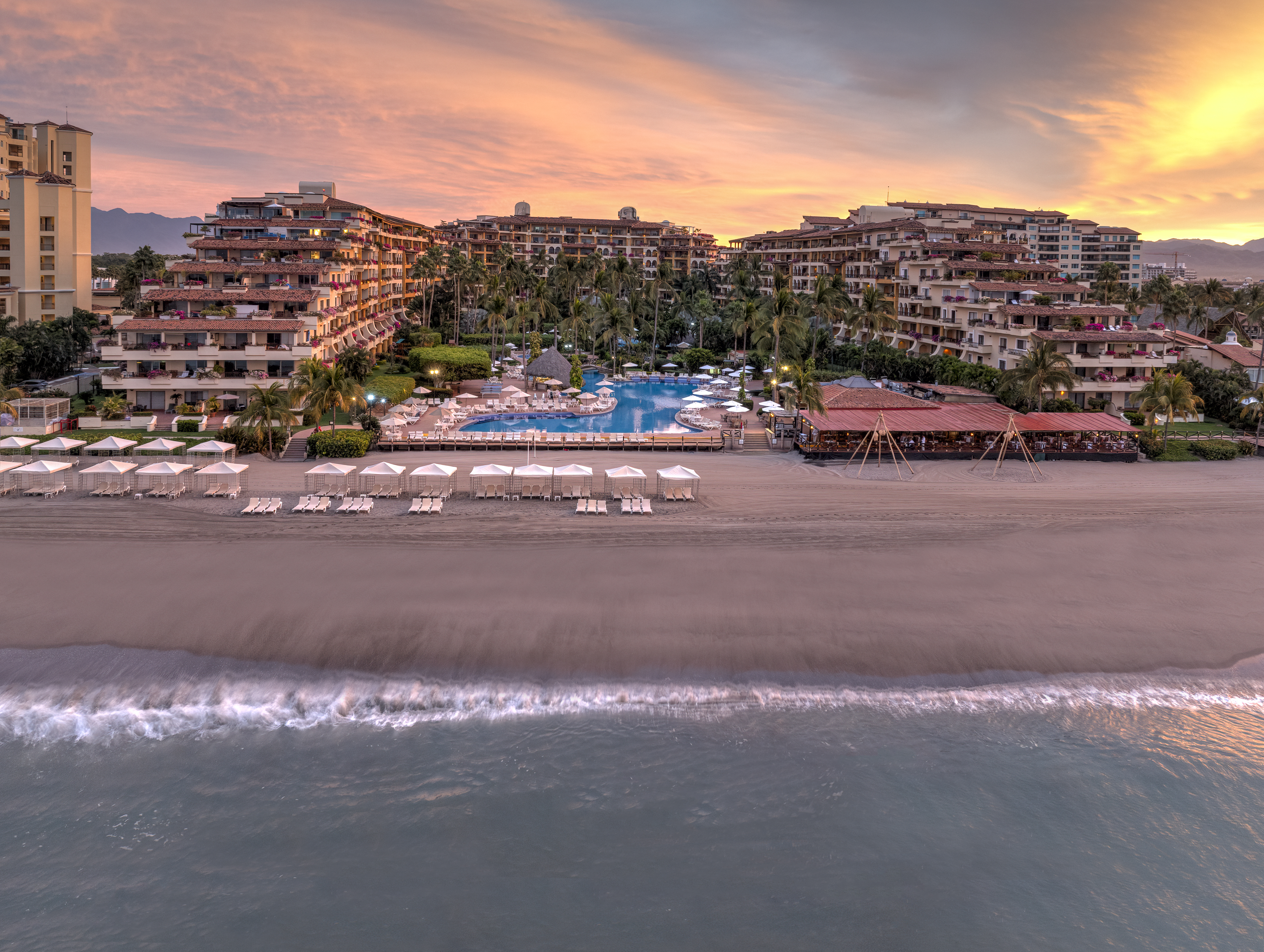 Drone view of Velas Vallarta pools, gardens, and Pacific coastline