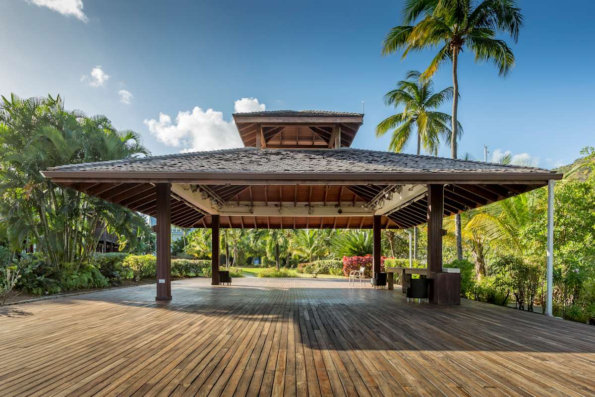 Lush tropical gardens with native St. Lucian plants and winding pathways throughout the hillside resort grounds