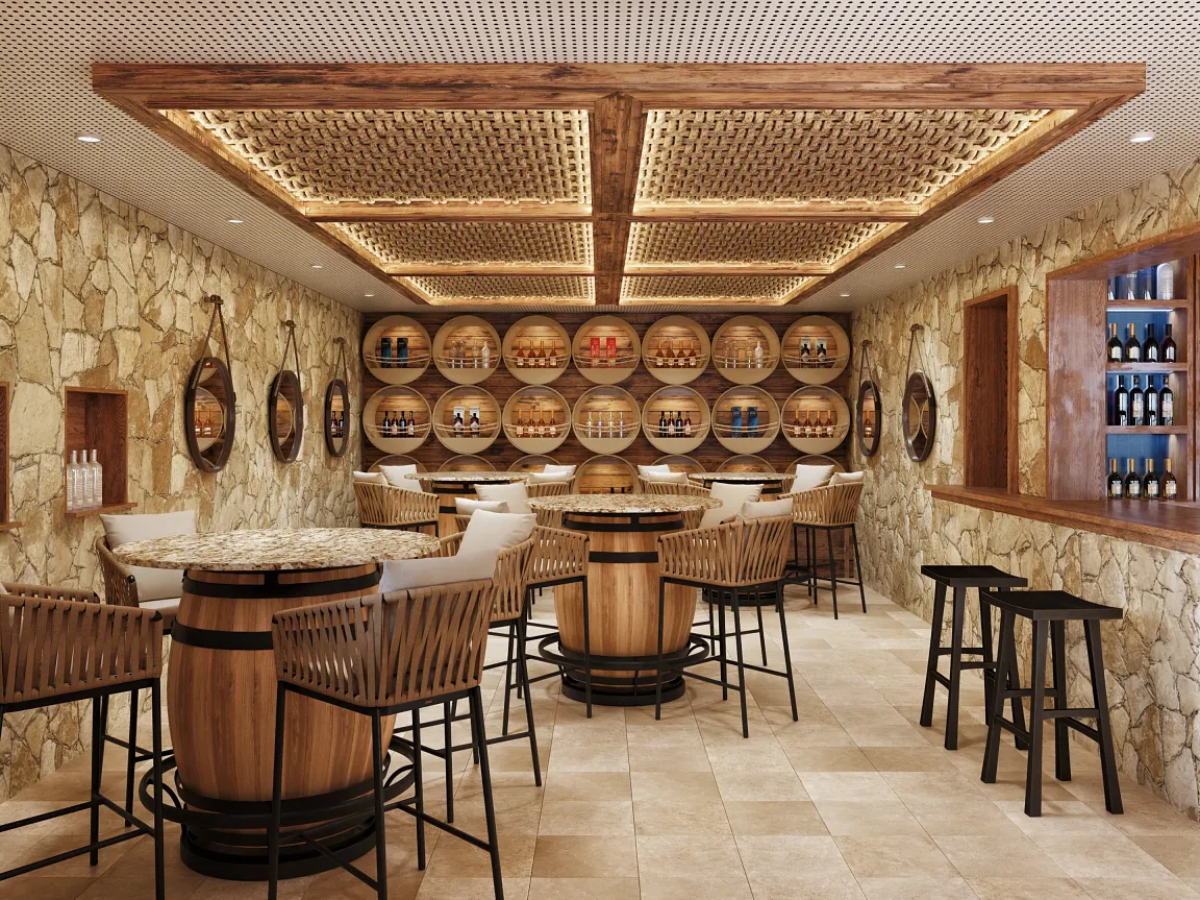 The Rum Cave featuring warm cave-like atmosphere with natural stone, wood barrels, and a curated selection of Caribbean rums