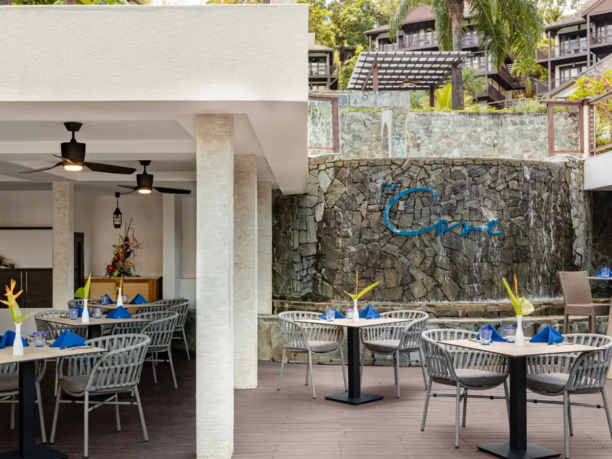 The Cove casual dining venue serving wood-fired pizzas, salads, and international fare in a relaxed poolside setting