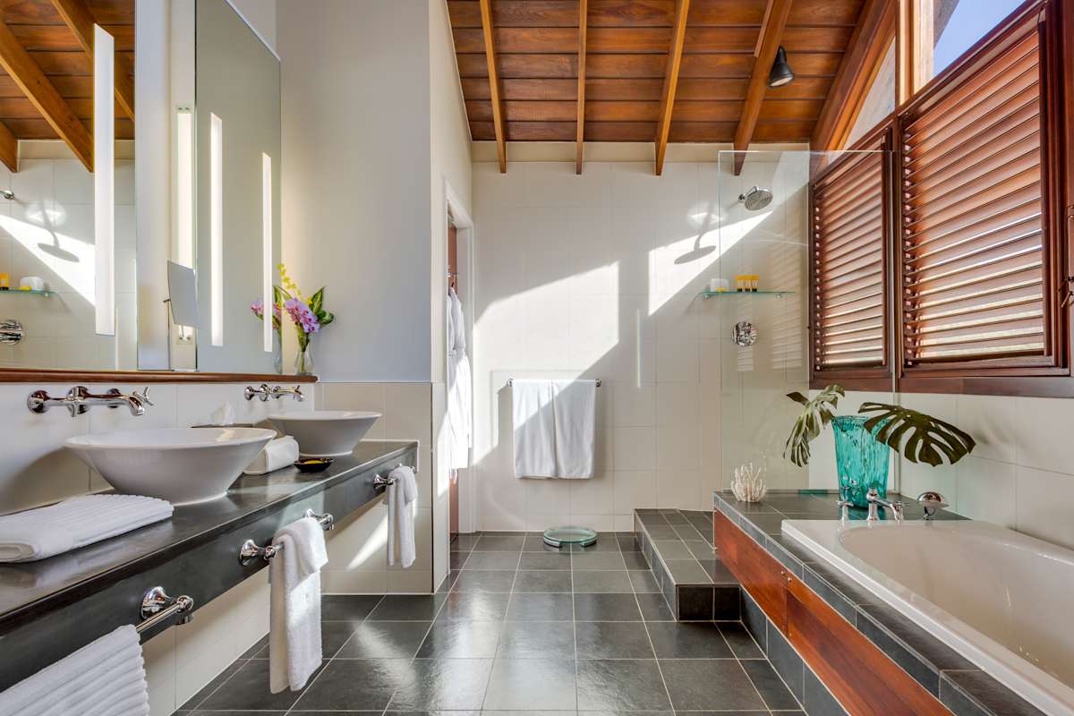 Penthouse Residence luxurious bathroom with freestanding soaking tub, rain shower, and marble finishes