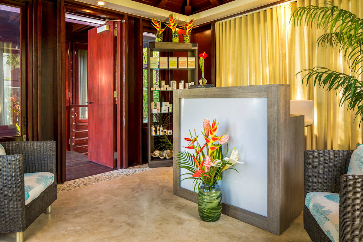 Spa relaxation area surrounded by lush tropical gardens with sauna, steam room, and meditation spaces